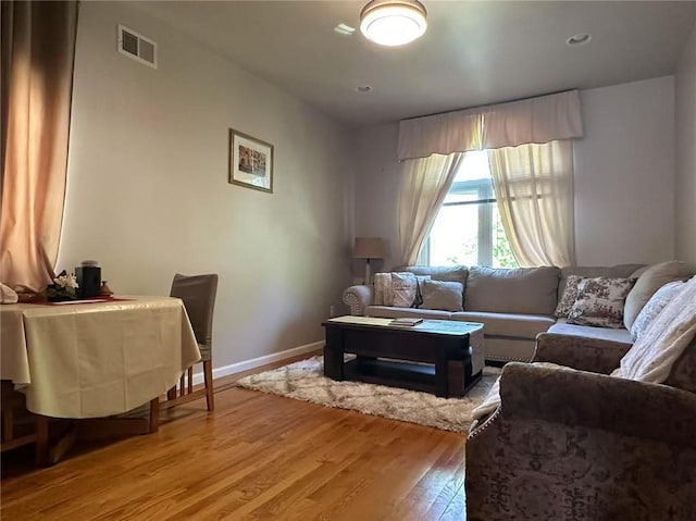 living room with light wood-style flooring and baseboards