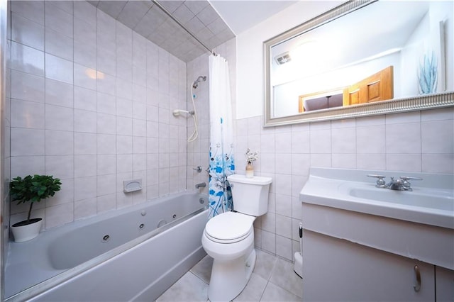 97 Debbie St Unit 97, Staten Island, NY 10314 - bathroom featuring tile walls, a combined bath / shower with jetted tub, vanity, toilet, and tile patterned floors