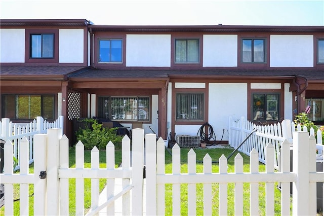 97 Debbie St Unit 97, Staten Island, NY 10314 - view of front of home with stucco siding, a fenced front yard, and a porch