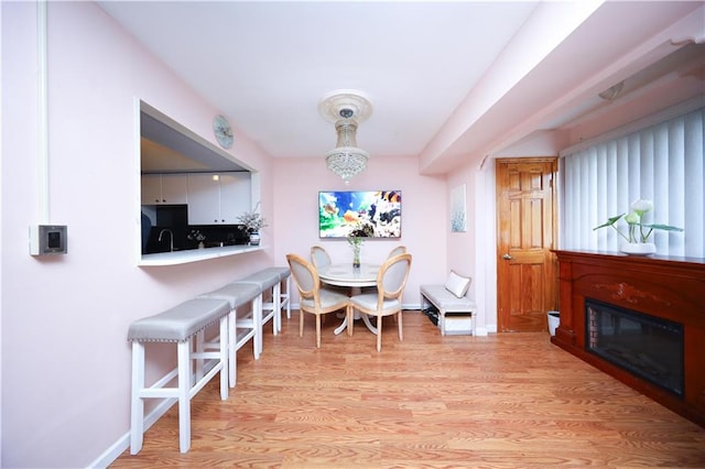 97 Debbie St Unit 97, Staten Island, NY 10314 - dining area with light wood-style flooring, baseboards, and a glass covered fireplace