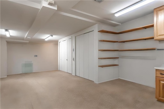 below grade area featuring light carpet and baseboards