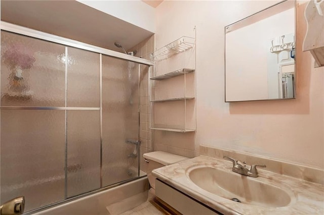 bathroom with bath / shower combo with glass door and vanity