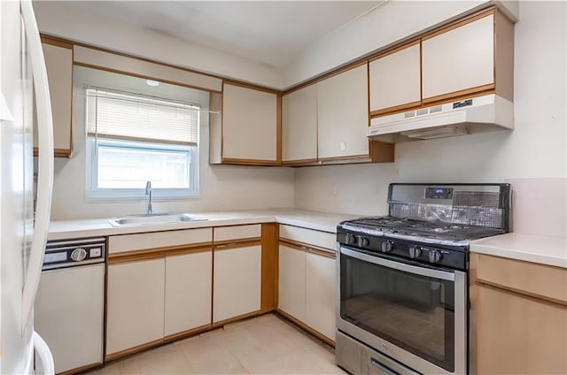 kitchen featuring white appliances, under cabinet range hood, a sink, and light countertops