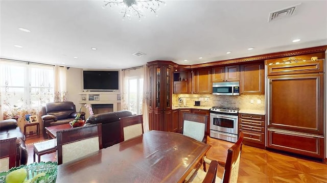 2421 Ocean Ave Unit 7A, Brooklyn, NY 11229 - kitchen with appliances with stainless steel finishes, healthy amount of natural light, a fireplace, decorative backsplash, and recessed lighting