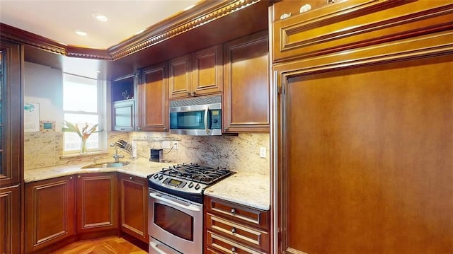 2421 Ocean Ave Unit 7A, Brooklyn, NY 11229 - kitchen featuring stainless steel appliances, a sink, light stone counters, decorative backsplash, and crown molding