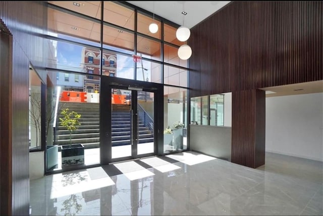 building lobby with a towering ceiling and floor to ceiling windows