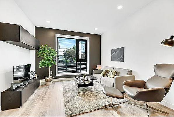 living room featuring wood finished floors, baseboards, and recessed lighting