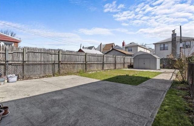 1505 E 54th St, Brooklyn, NY 11234 - fenced backyard featuring a storage shed, a patio area, and an outbuilding