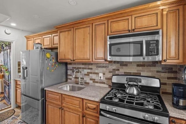 1505 E 54th St, Brooklyn, NY 11234 - kitchen with appliances with stainless steel finishes, a sink, decorative backsplash, and brown cabinetry