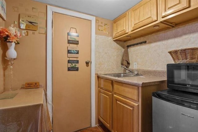 1505 E 54th St, Brooklyn, NY 11234 - kitchen featuring black microwave, decorative backsplash, a sink, fridge, and light countertops