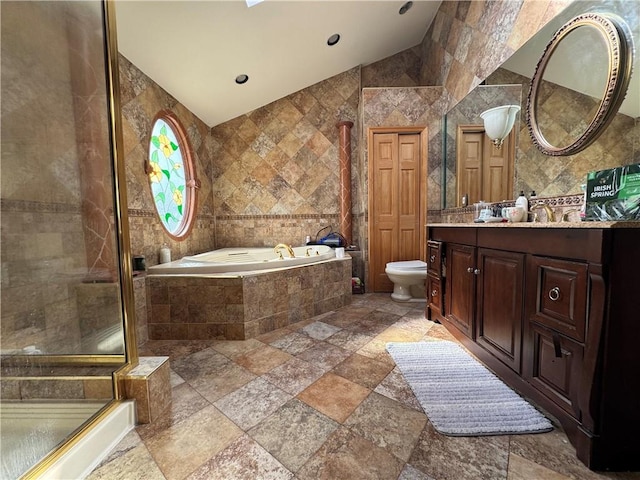 full bath featuring stone tile floors, tile walls, vaulted ceiling, a bath, and a stall shower