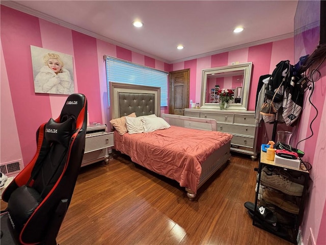 bedroom with dark wood-style floors, ornamental molding, and recessed lighting