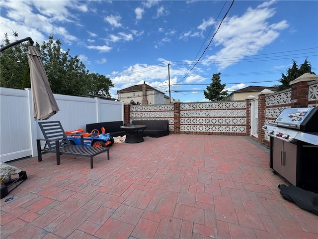 view of patio featuring a fenced backyard and a grill