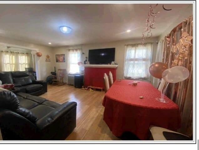 19907 100th Ave, Hollis, NY 11423 - living area with wood finished floors and radiator