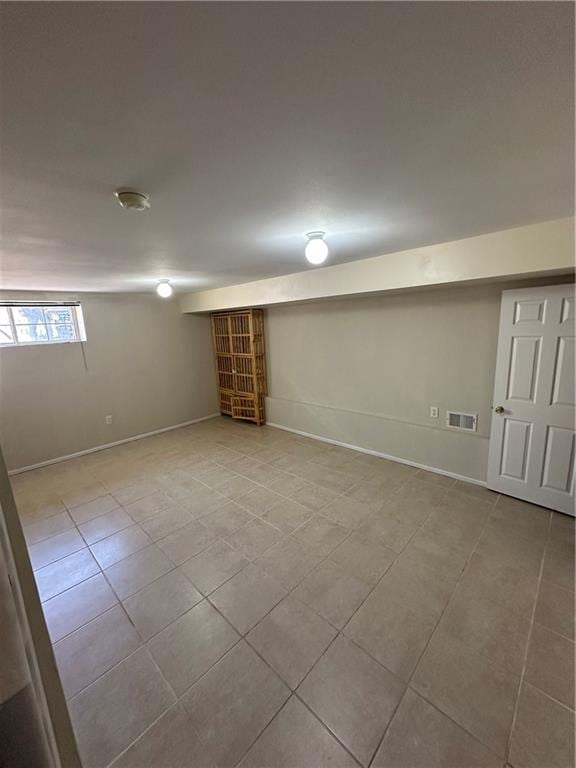 basement with tile patterned flooring and baseboards