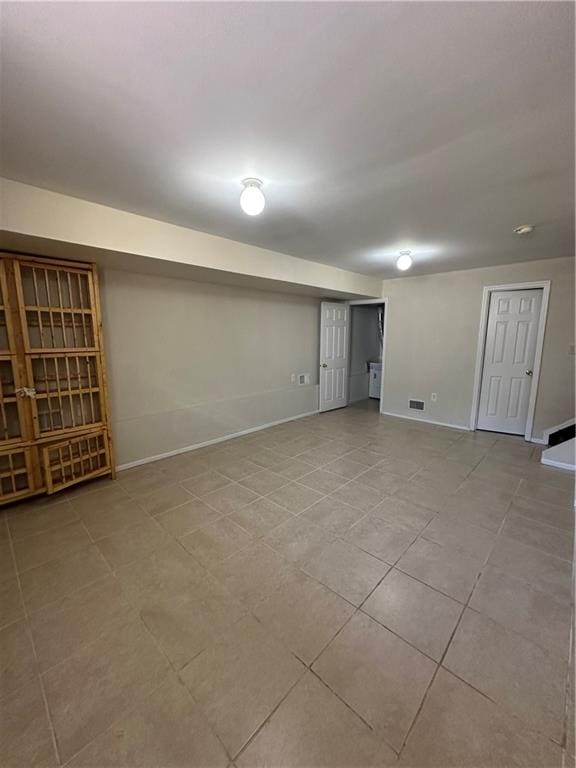 basement with tile patterned flooring and baseboards