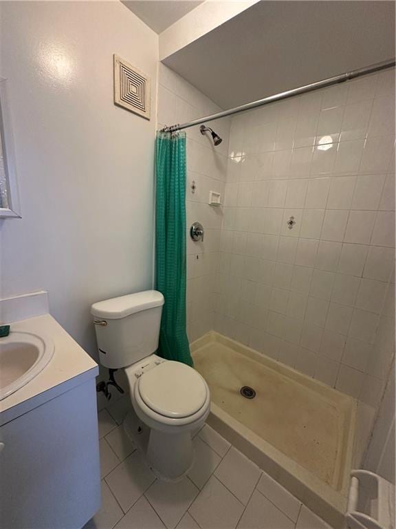 full bathroom with tile patterned floors, a stall shower, toilet, and vanity
