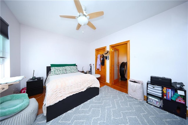 bedroom featuring a ceiling fan and wood finished floors