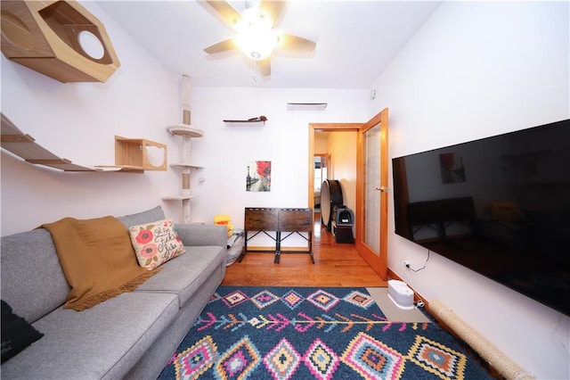 living area featuring wood finished floors and a ceiling fan