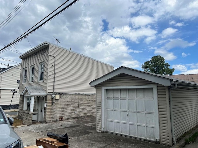 view of side of property featuring an outbuilding and a detached garage