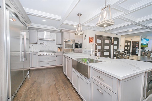 30-30 78th St, Queens, NY 11370 - kitchen featuring stainless steel appliances, wall chimney exhaust hood, a sink, coffered ceiling, and gray cabinetry