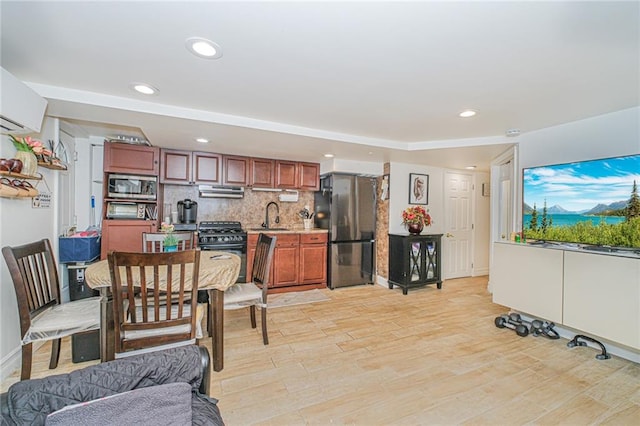 30-30 78th St, Queens, NY 11370 - kitchen featuring stainless steel appliances, backsplash, light countertops, a sink, and recessed lighting