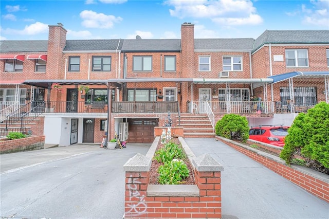 30-30 78th St, Queens, NY 11370 - view of front of home with a chimney, brick siding, and driveway