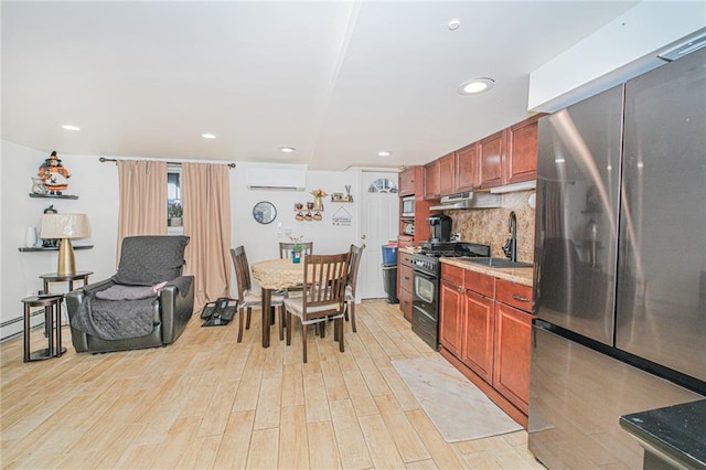30-30 78th St, Queens, NY 11370 - kitchen featuring stainless steel appliances, a wall mounted air conditioner, a sink, light wood-style flooring, and tasteful backsplash