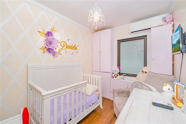 30-30 78th St, Queens, NY 11370 - bedroom with a wall mounted air conditioner, wood finished floors, crown molding, and a crib