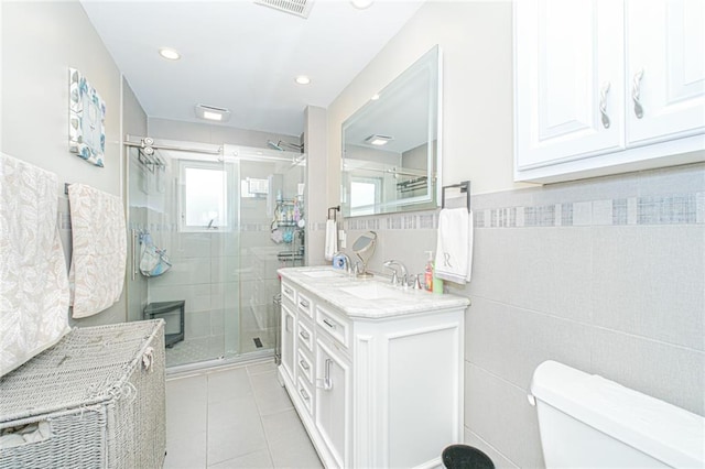 30-30 78th St, Queens, NY 11370 - bathroom featuring toilet, tile walls, a shower stall, tile patterned flooring, and recessed lighting