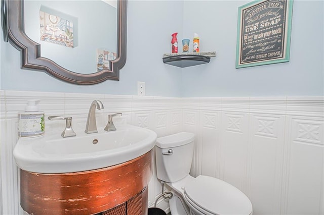 30-30 78th St, Queens, NY 11370 - bathroom featuring vanity, toilet, and a wainscoted wall