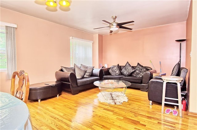 living room with wood finished floors and ceiling fan