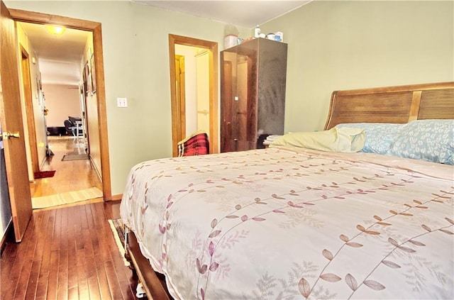 bedroom with dark wood finished floors