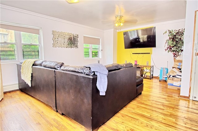 living area with wood finished floors, ornamental molding, and a ceiling fan