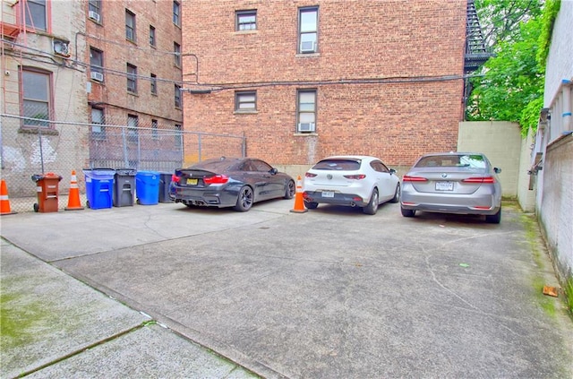 uncovered parking lot featuring cooling unit