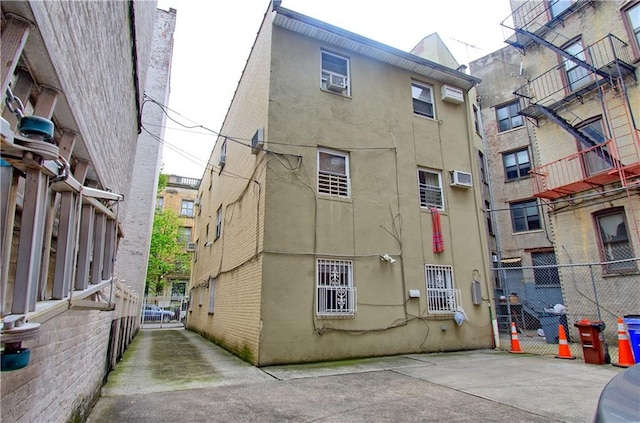 rear view of property featuring stucco siding and an AC wall unit