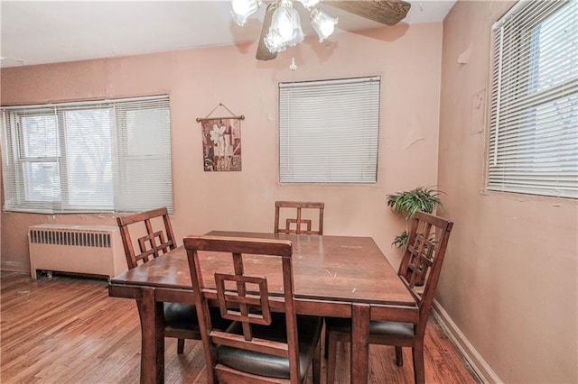 1333 Shore Pkwy Unit A, Brooklyn, NY 11214 - dining area with radiator, wood finished floors, a ceiling fan, and baseboards