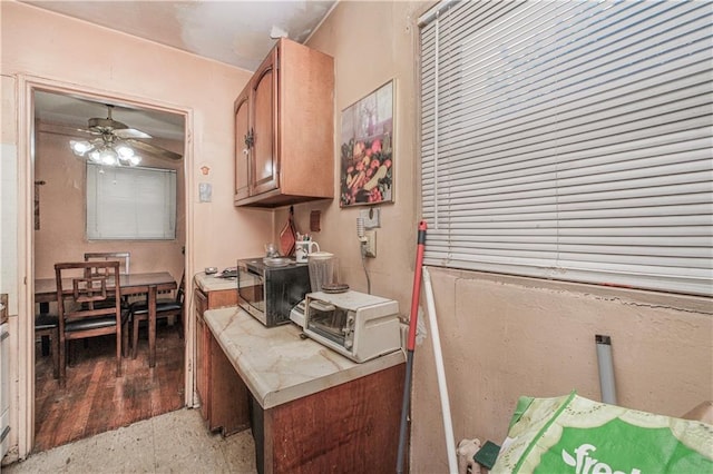 1333 Shore Pkwy Unit A, Brooklyn, NY 11214 - kitchen with stainless steel microwave, ceiling fan, and brown cabinetry