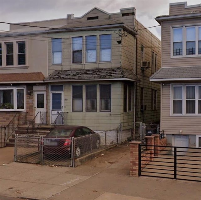 multi unit property with a fenced front yard and a gate