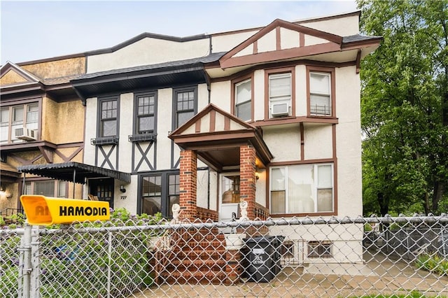 townhome / multi-family property featuring stucco siding and cooling unit