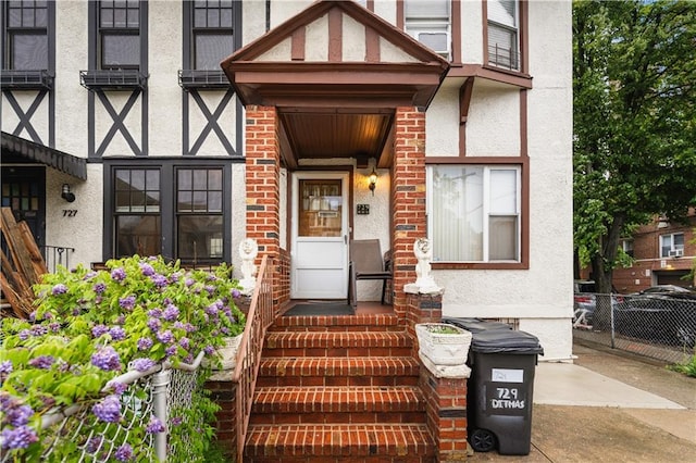 entrance to property with stucco siding and brick siding