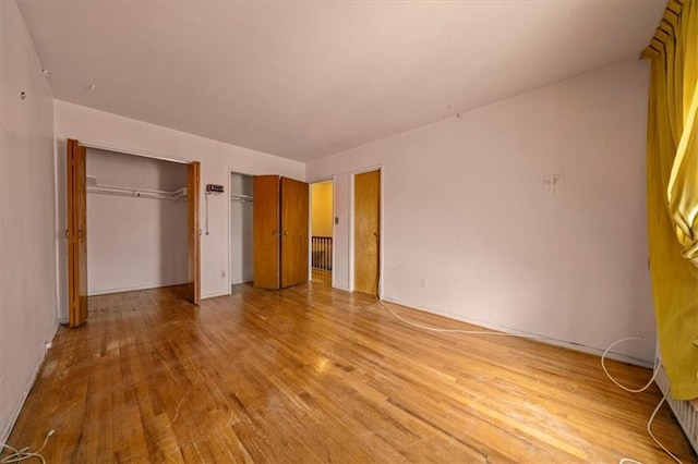328 Wortman Ave, Brooklyn, NY 11207 - unfurnished bedroom featuring light wood finished floors and two closets