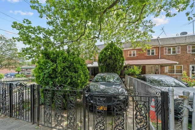 328 Wortman Ave, Brooklyn, NY 11207 - view of front facade featuring brick siding and a gate