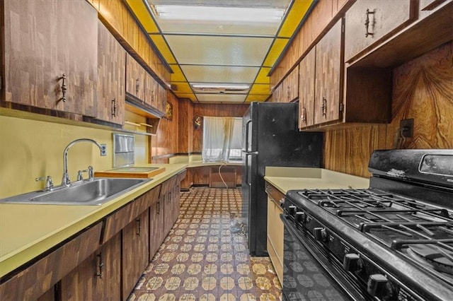 328 Wortman Ave, Brooklyn, NY 11207 - kitchen with black appliances, a sink, light flooring, and light countertops