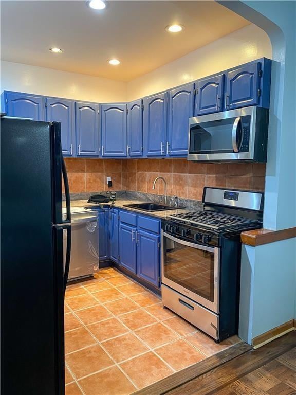 156 E 88th St, Brooklyn, NY 11236 - kitchen with stainless steel appliances, blue cabinetry, backsplash, arched walkways, and recessed lighting