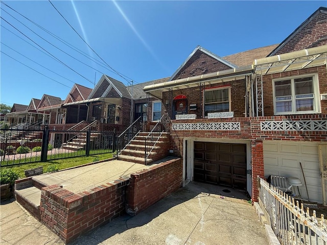 156 E 88th St, Brooklyn, NY 11236 - view of front of home featuring a garage, brick siding, concrete driveway, and a porch