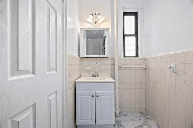 1680 Ocean Ave Unit 4H, Brooklyn, NY 11230 - bathroom featuring tile walls, vanity, and a wainscoted wall