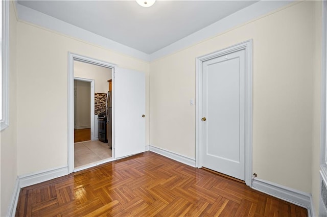 1680 Ocean Ave Unit 4H, Brooklyn, NY 11230 - unfurnished bedroom featuring baseboards, freestanding refrigerator, ensuite bath, and a closet