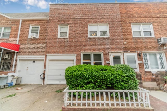 1484 E 16th St, Brooklyn, NY 11230 - townhome / multi-family property featuring brick siding, driveway, a garage, and cooling unit