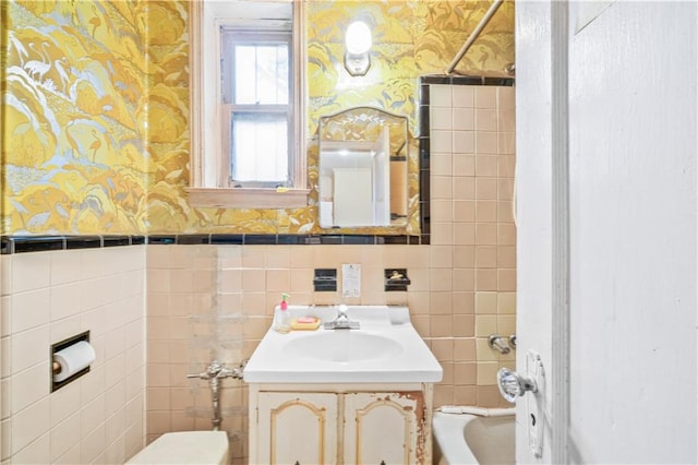 1484 E 16th St, Brooklyn, NY 11230 - full bathroom with wallpapered walls, tile walls, vanity, toilet, and bathtub / shower combination